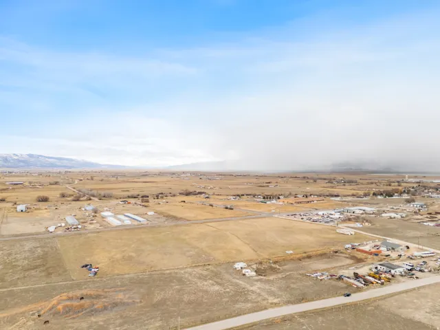 Expansive agricultural landscape with distant mountain ranges under a broad sky