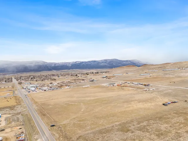 Expansive land parcel featuring open fields and distant mountain ranges