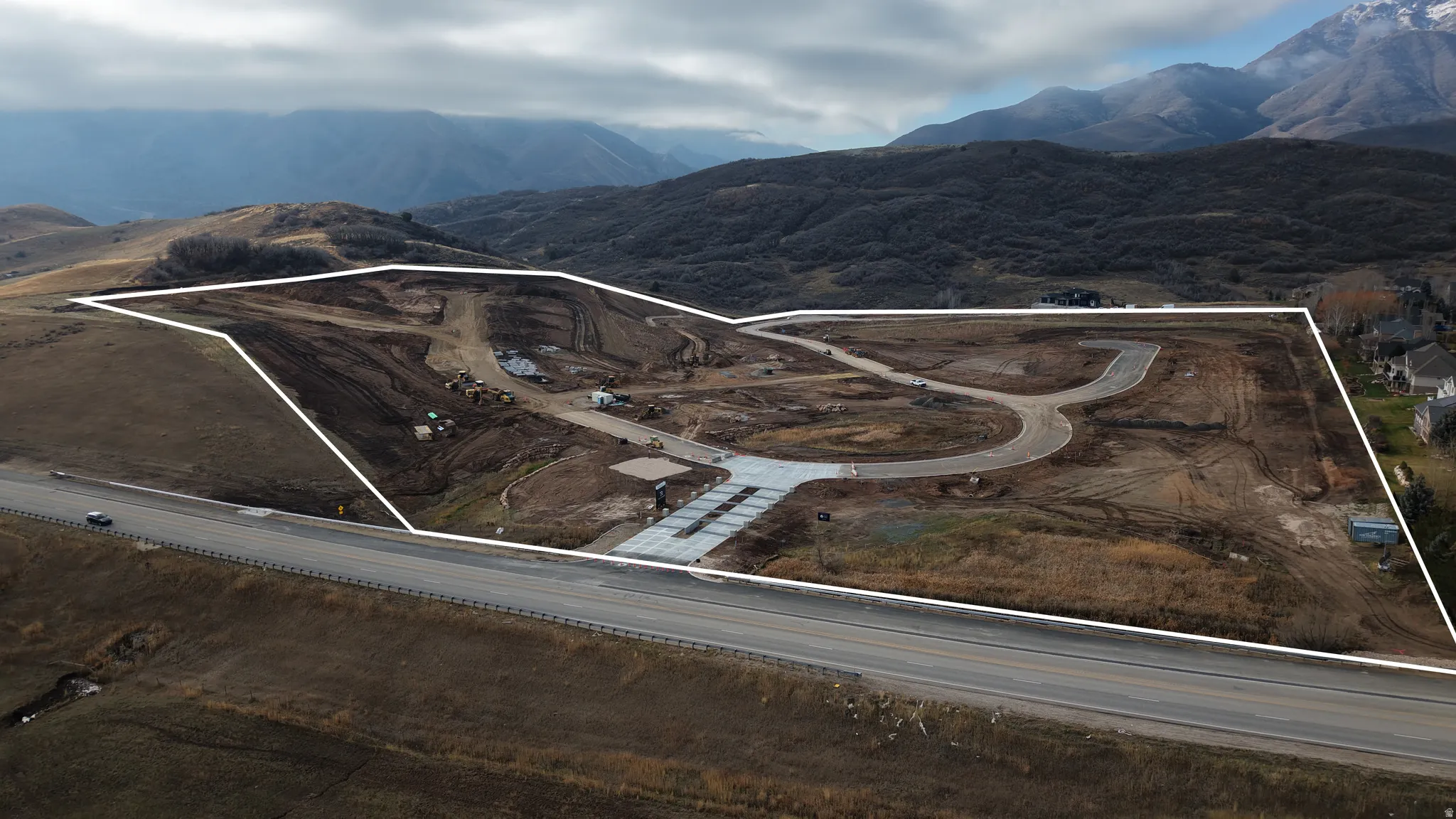 Developed land parcel featuring graded terrain, paved road frontage, and established internal roadways