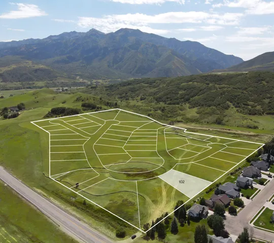 Aerial view highlighting a developing subdivision with delineated lots