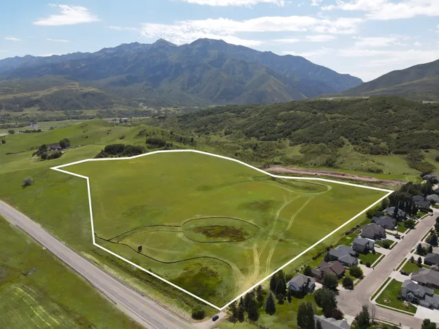 Expansive, undeveloped land parcel featuring a lush green field