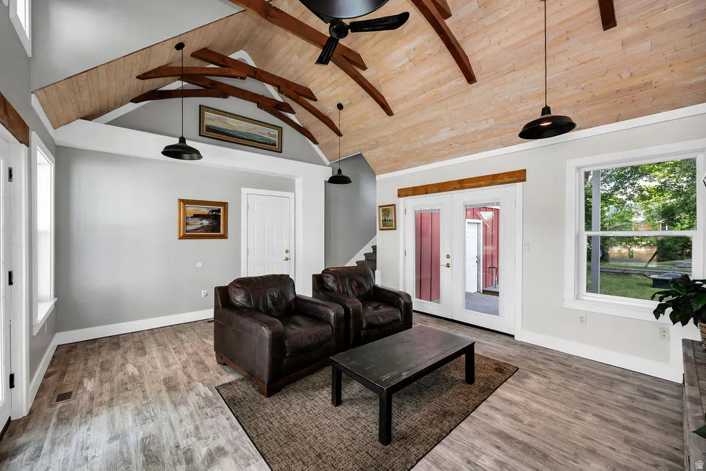 Vaulted wood-paneled ceiling with exposed wood beams and industrial-style pendant lighting