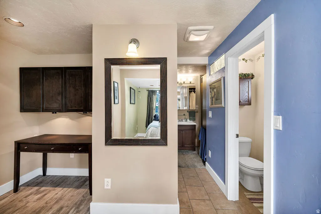 Master bedroom featuring wood-finish flooring and ceramic tile flooring