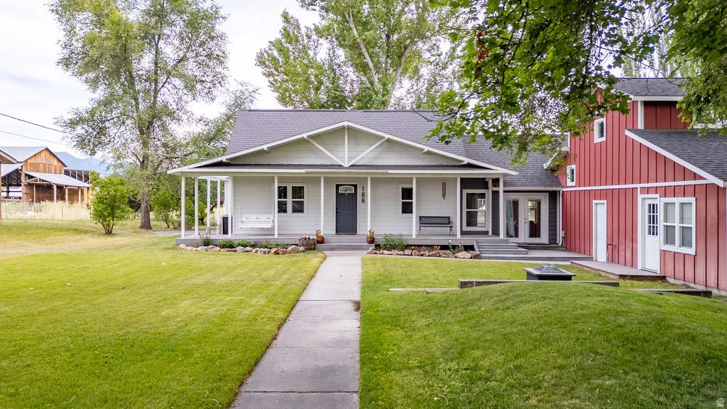 White siding residence with a covered front porch featuring white columns