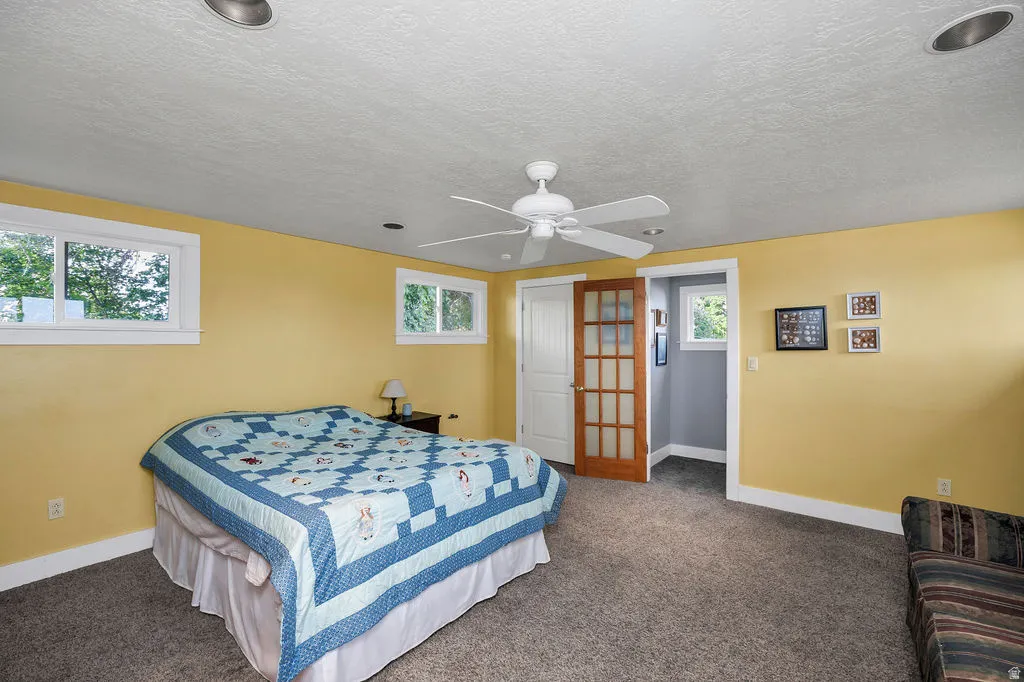 Spacious room with plush carpeting, recessed lighting, and a ceiling fan
