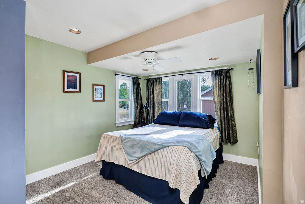 Master bedroom featuring a ceiling fan, recessed lighting, and multiple windows