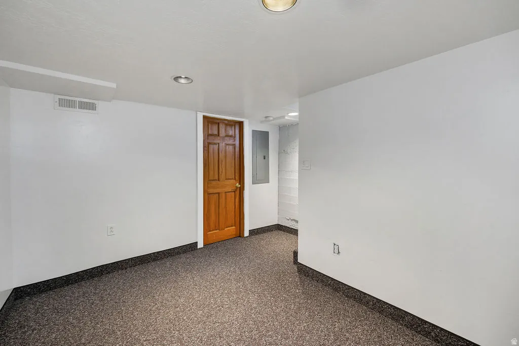 Room featuring speckled flooring, white walls, and recessed lighting
