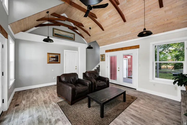 Vaulted wood-paneled ceiling with exposed wood beams and industrial-style pendant lighting