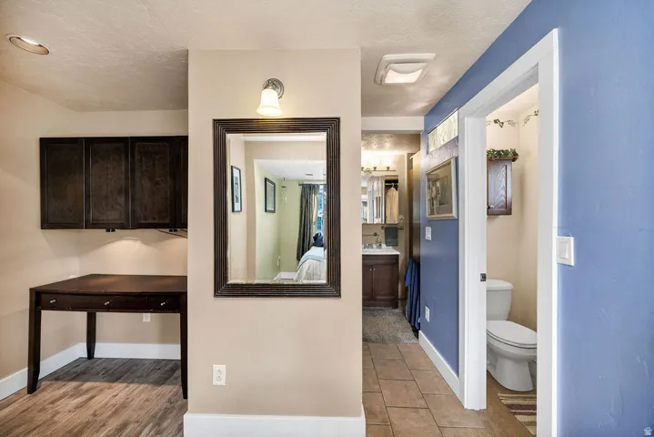 Master bedroom featuring wood-finish flooring and ceramic tile flooring