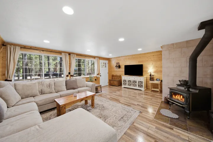 Living area featuring wood-finish flooring, recessed lighting, and wood plank wall finishes