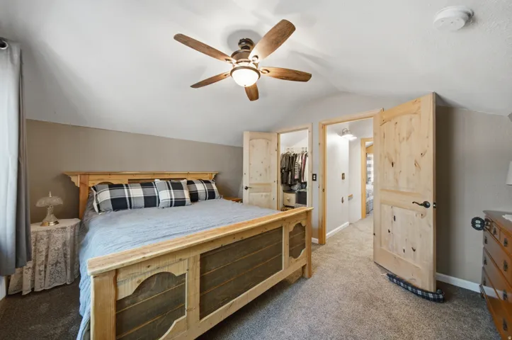 Bedroom featuring vaulted ceilings and neutral wall tones