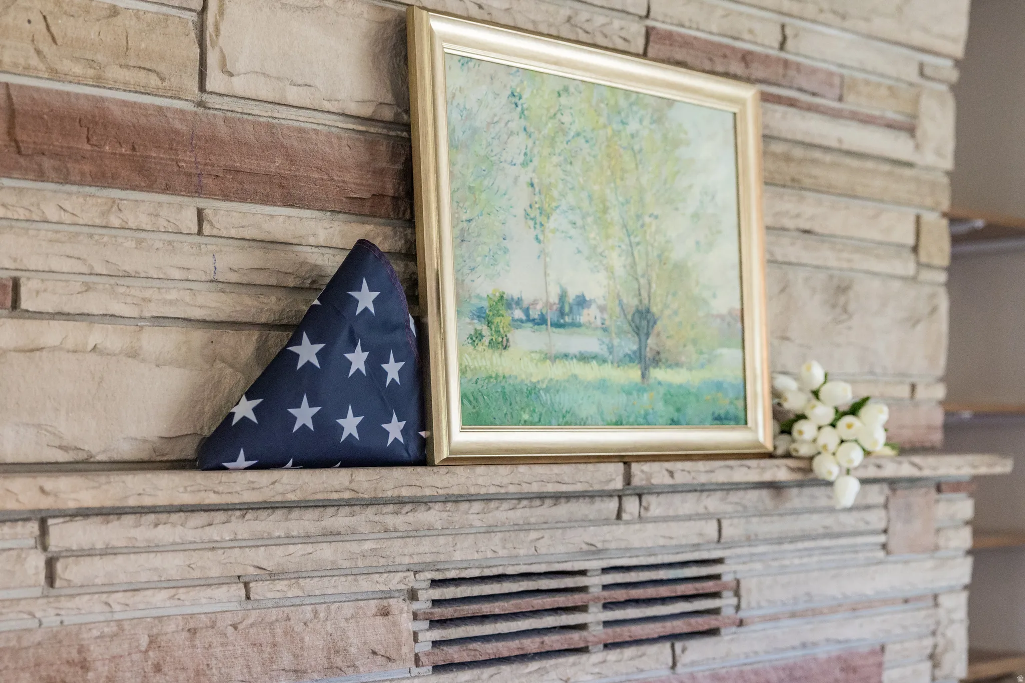 Stone-clad fireplace with a prominent mantel
