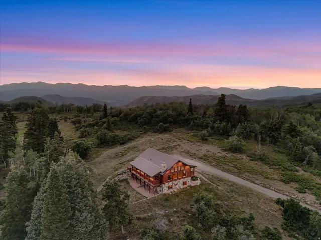 Rustic mountain home with a metal roof and stone foundation