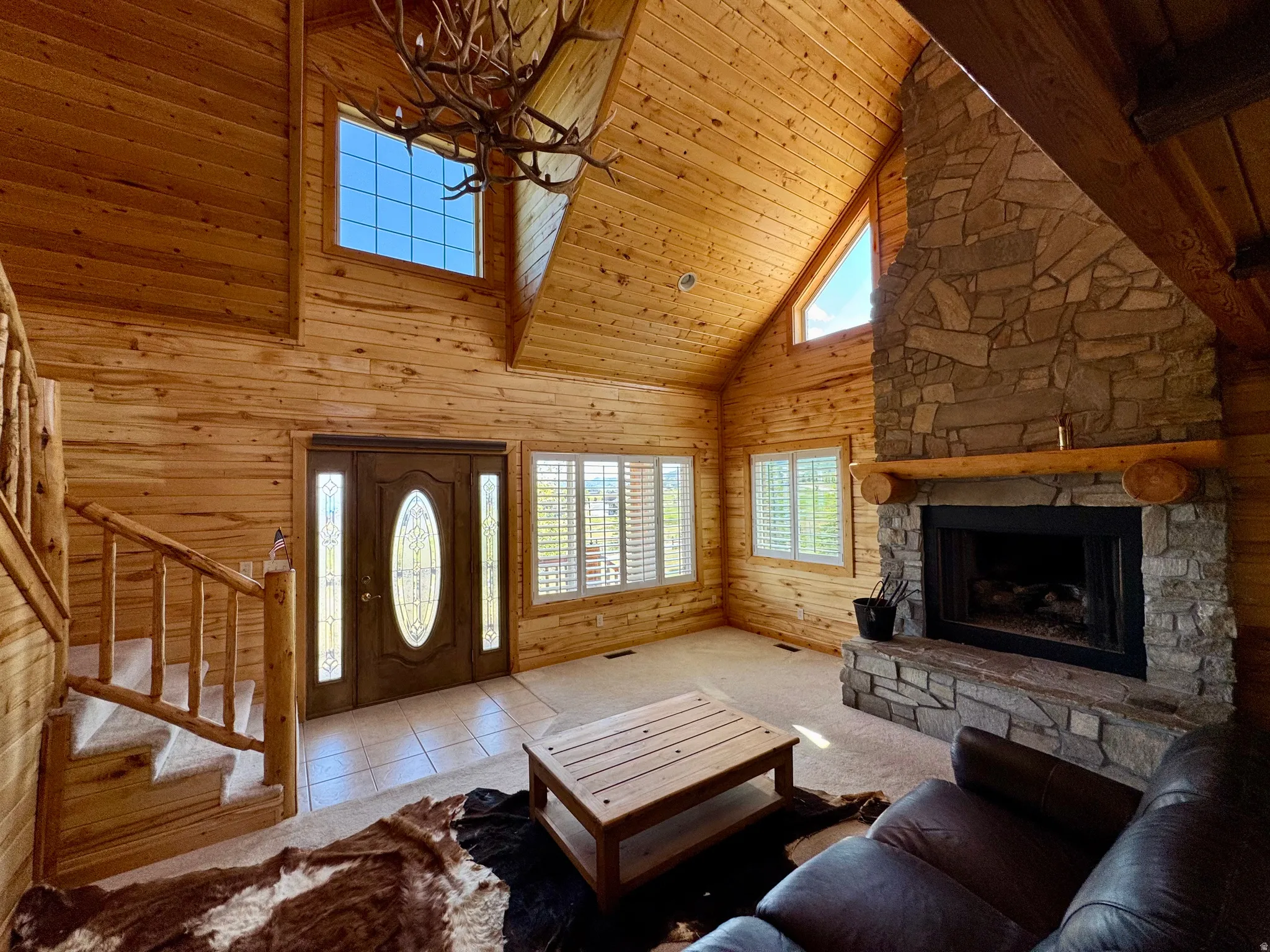 Vaulted wood-paneled ceiling with an antler-style chandelier