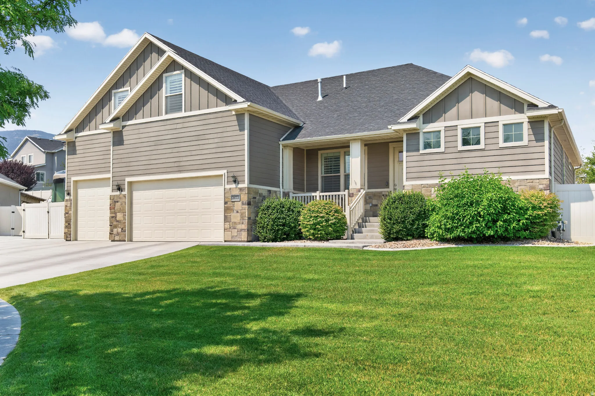 Contemporary residence featuring a two-car garage and an additional single-car garage