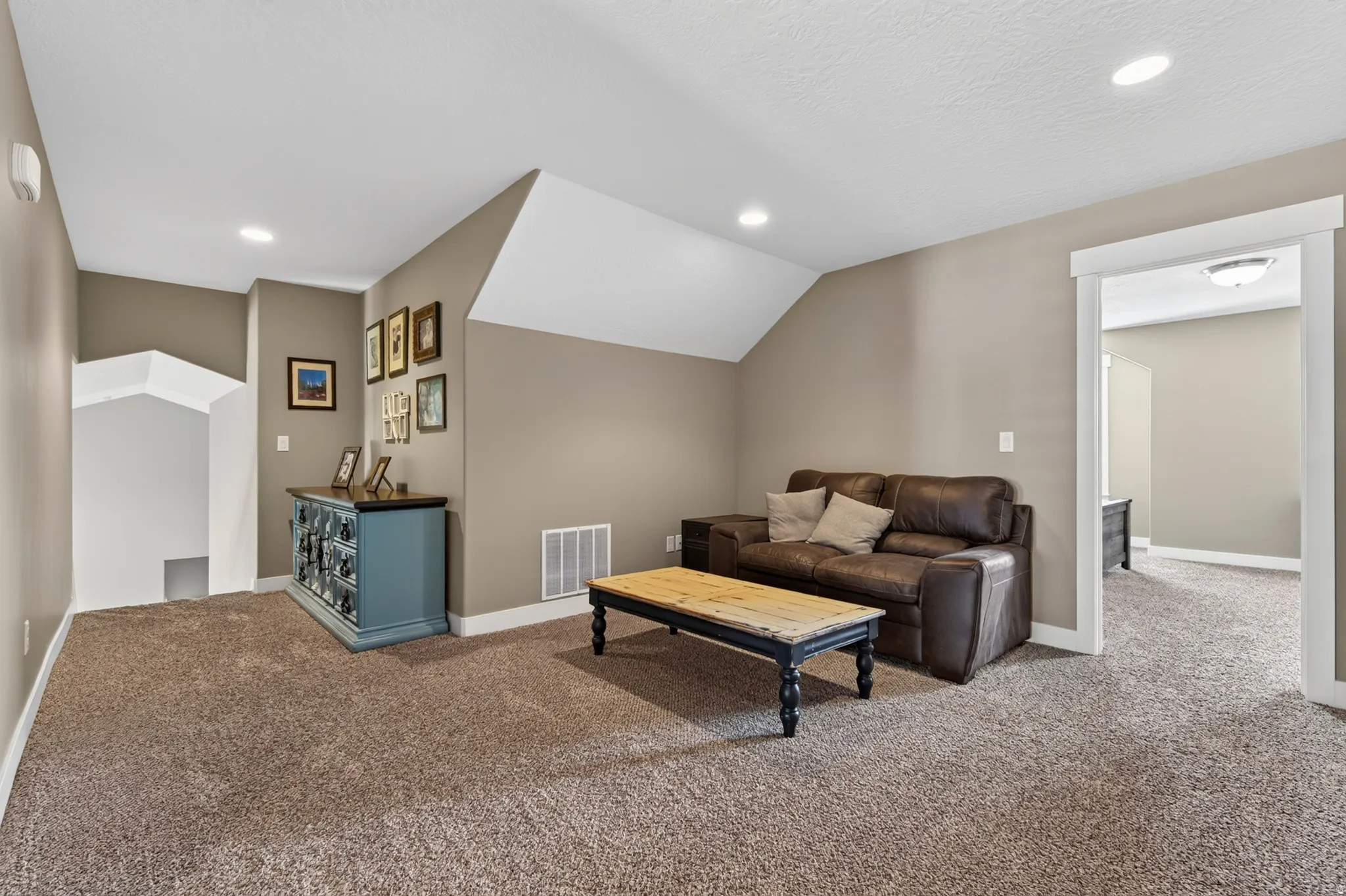 Carpeted room with recessed lighting and neutral wall tones