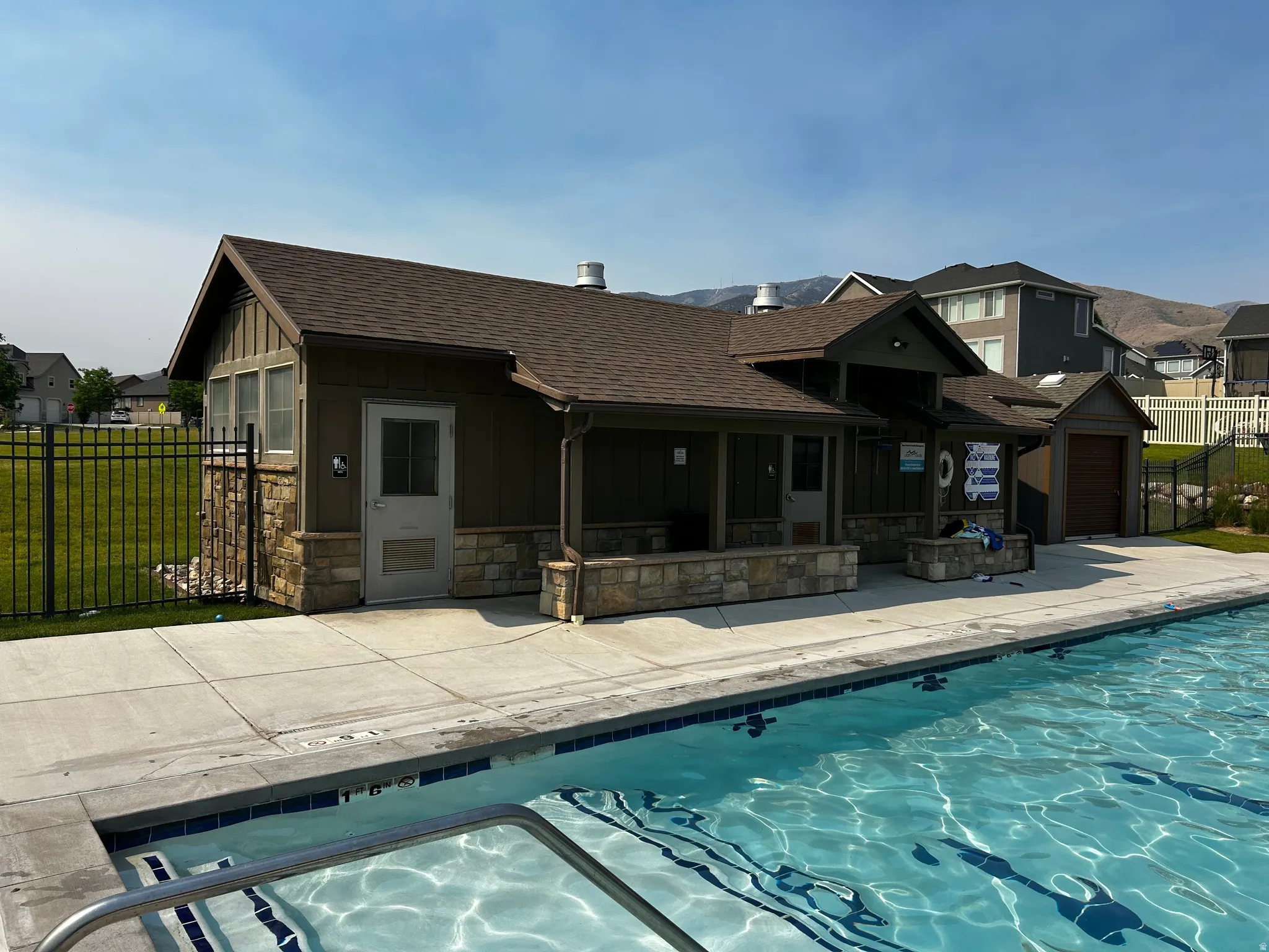 Inviting outdoor swimming pool with integrated steps and a surrounding concrete patio