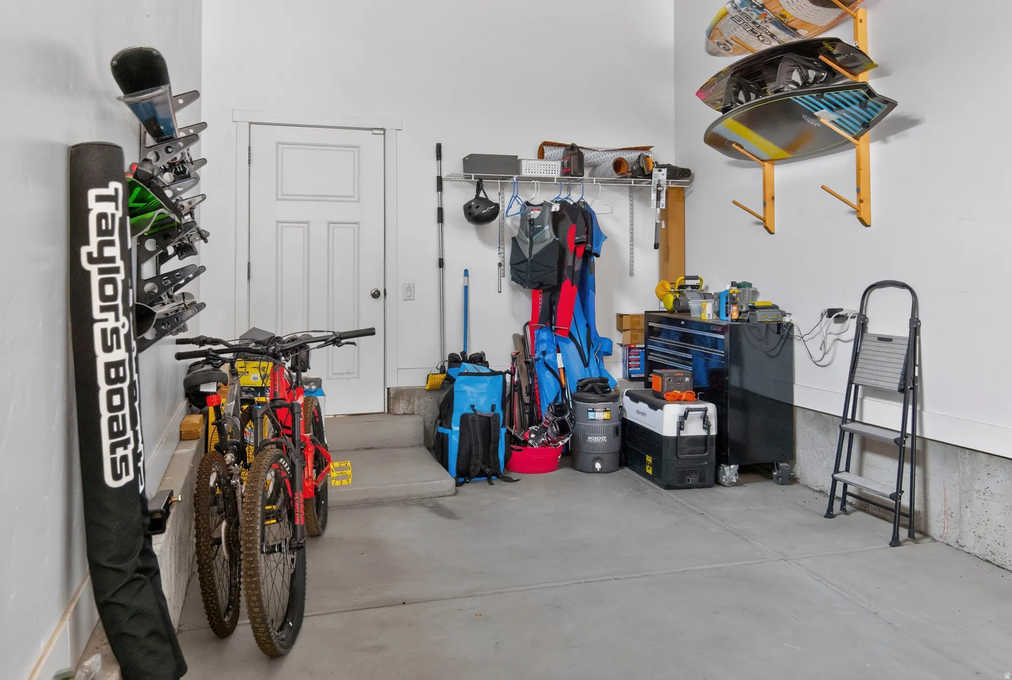 Spacious garage featuring a concrete floor, painted walls, and an interior access door