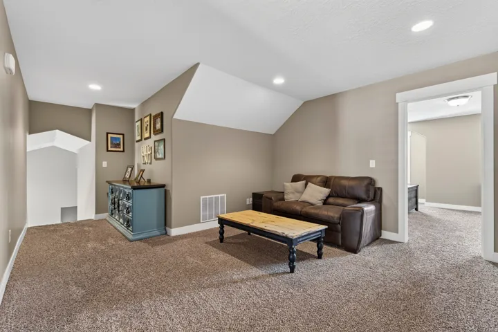 Carpeted room with recessed lighting and neutral wall tones