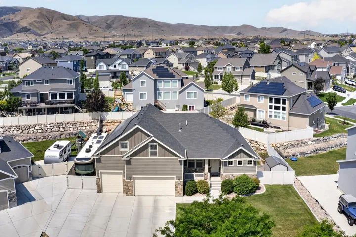 Two-story residence featuring a two-car garage and a paved driveway