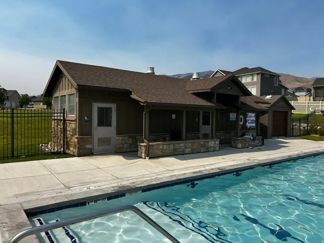 Inviting outdoor swimming pool with integrated steps and a surrounding concrete patio