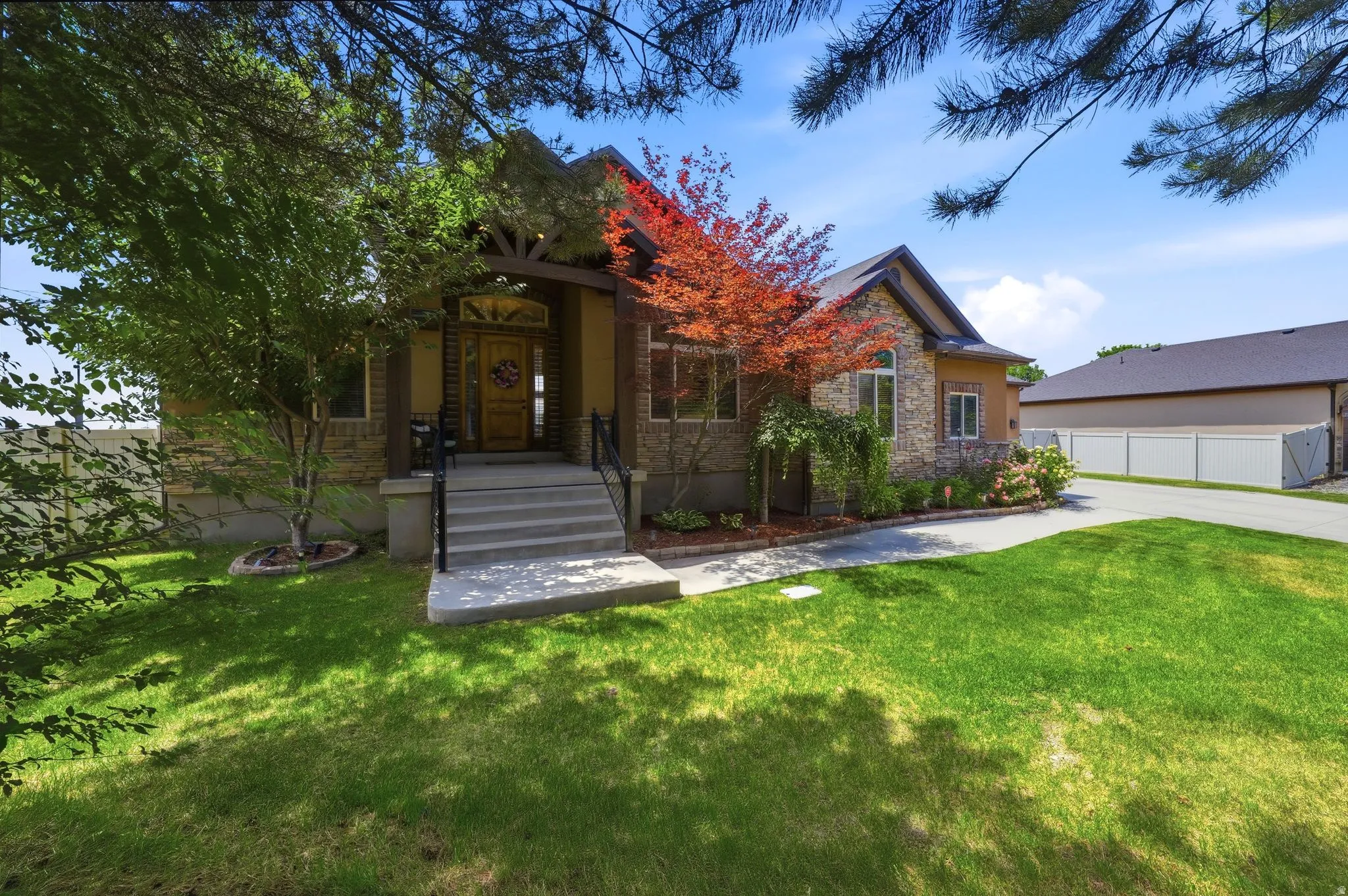 Stone and stucco exterior with a prominent gabled entry featuring decorative wood beams