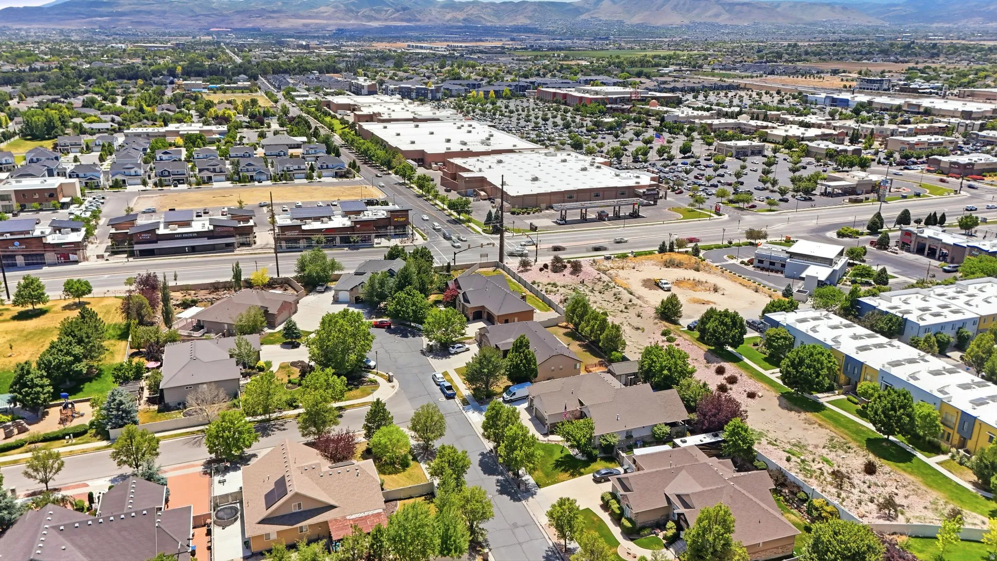 The District is close by. Aerial perspective showcasing a residential area with varied housing styles
