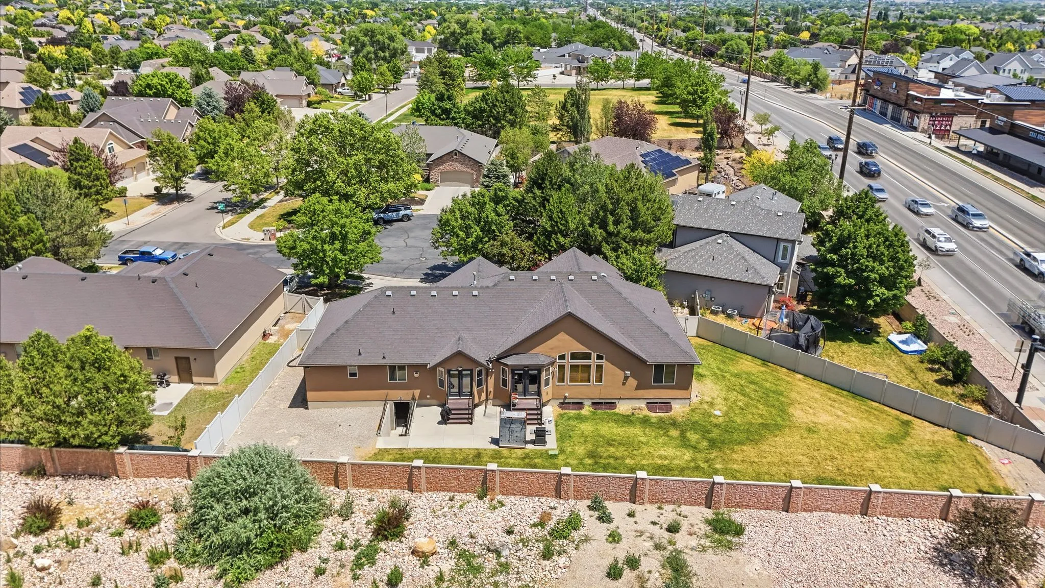 Expansive property featuring a large private yard with a manicured lawn, an outdoor patio, and a privacy fence