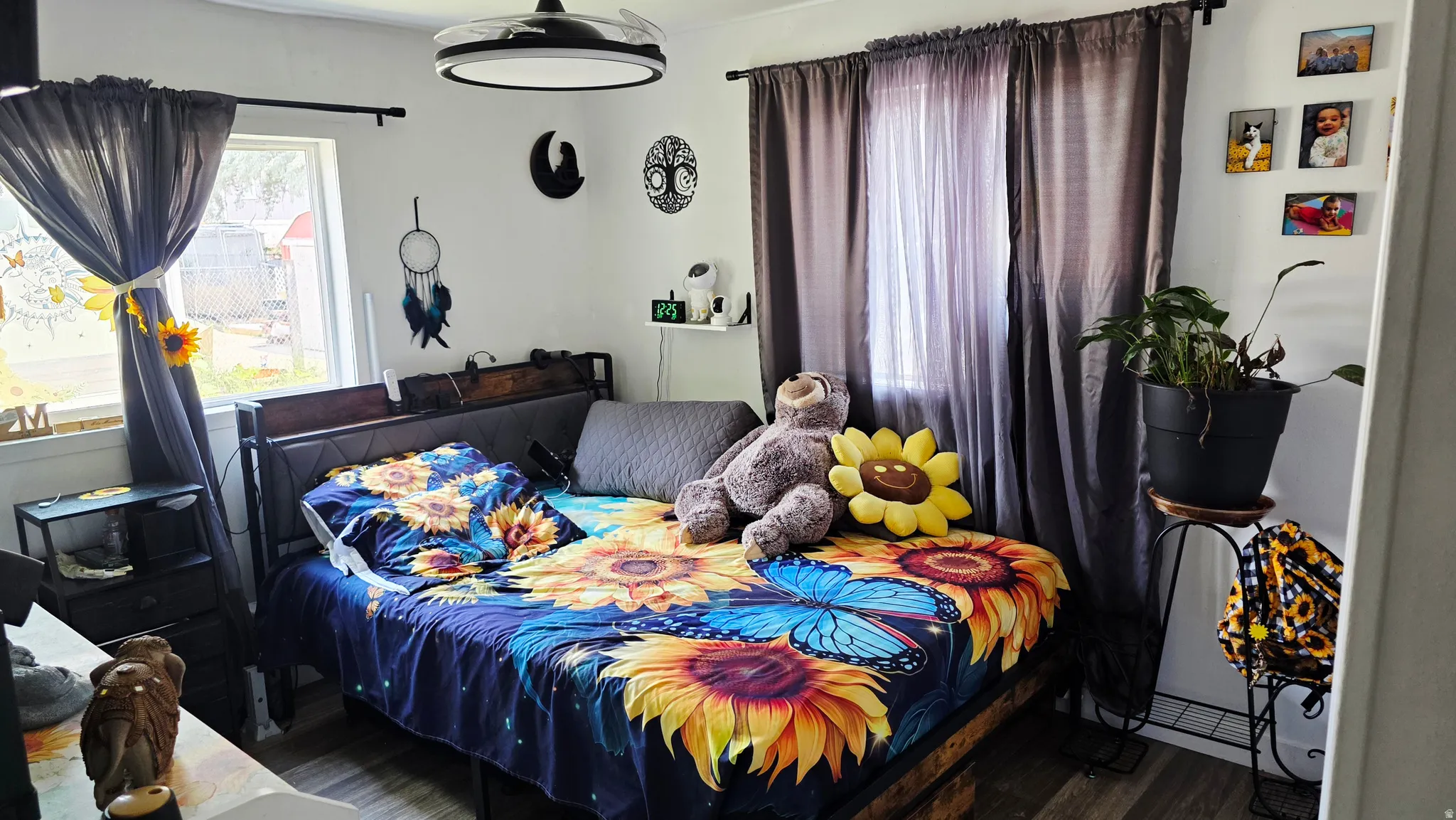 Bedroom space featuring light-toned walls and wood-finish flooring