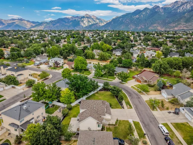 Residential community featuring extensive tree canopies and mountainous backdrops
