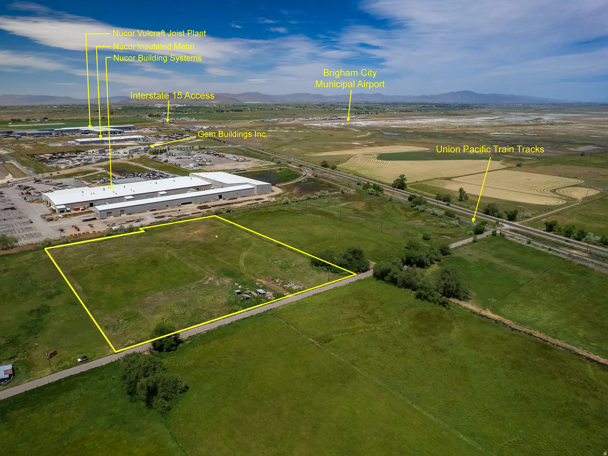 Expansive land parcel featuring direct road frontage and a verdant, undeveloped landscape outlined in yellow, featuring a predominantly green, grassy surface including three parcels, Parcel # 03-077-0015, and adjacent parcel available for sale MLS 2163865