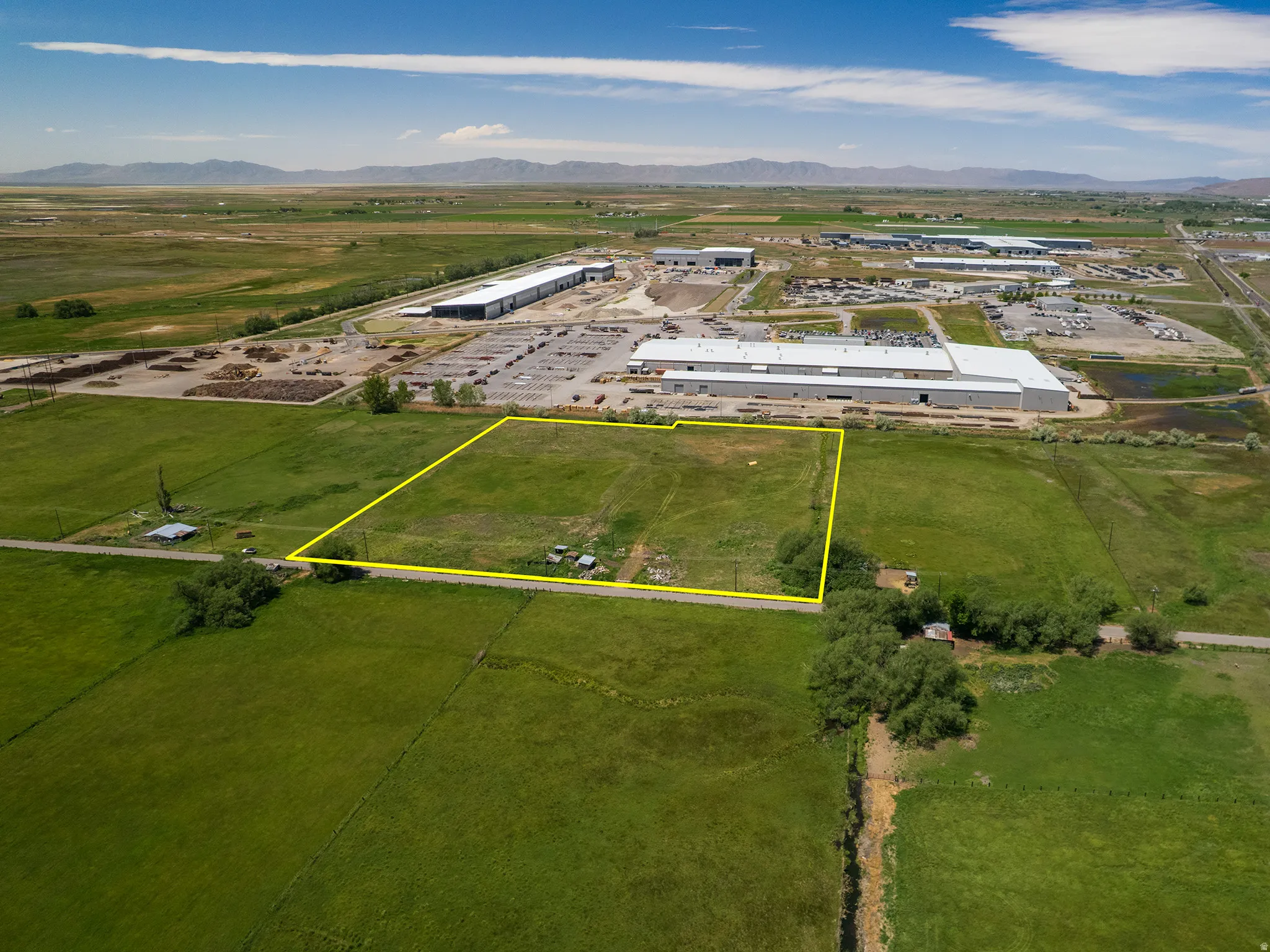 Expansive parcel of undeveloped land outlined in yellow, featuring a predominantly green, grassy surface including Parcel # 03-077-0015, and adjacent parcel available for sale MLS 2163865 (Parcel #'s 03-077-0011 and 03-077-0012) for a footprint of 8.94 Ac
