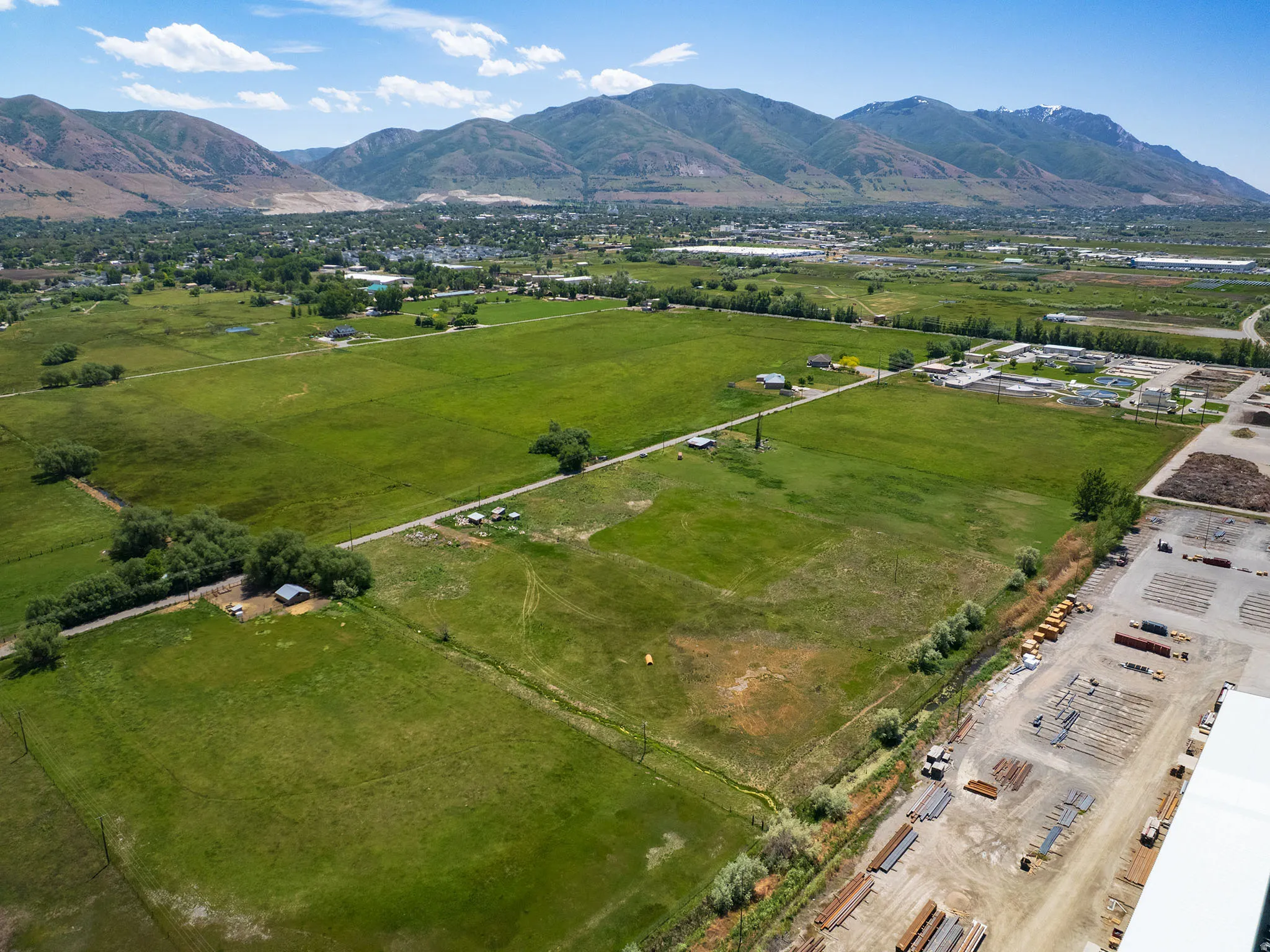 Expansive green fields with distant mountains forming a natural backdrop