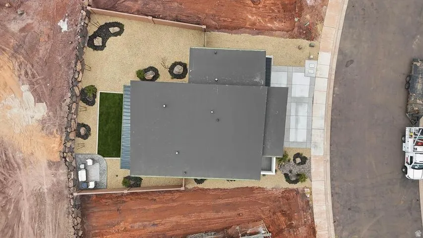 Contemporary roofline with a large gravel yard, segmented turf area, and paver patio