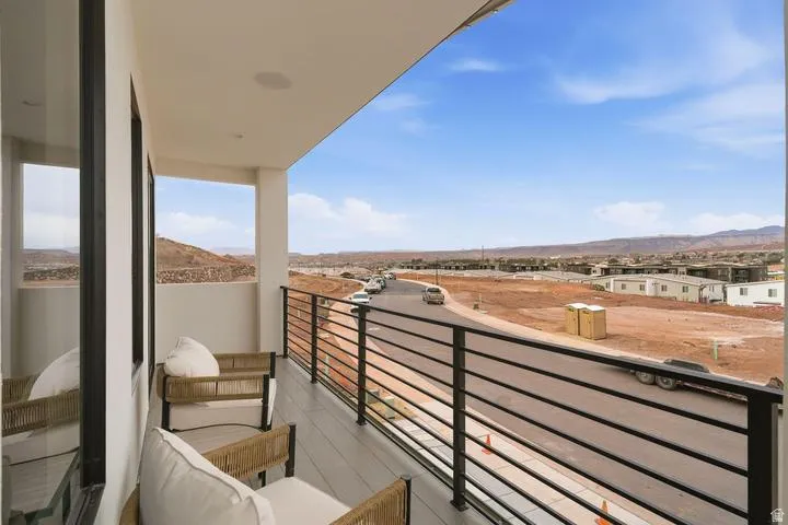 Covered balcony with composite decking, modern horizontal railing, recessed lighting, and built-in ceiling speakers