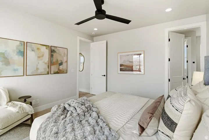 Bedroom featuring light gray walls, a black ceiling fan, and recessed lighting