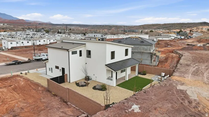 Contemporary two-story residence featuring a white stucco exterior and black-framed windows