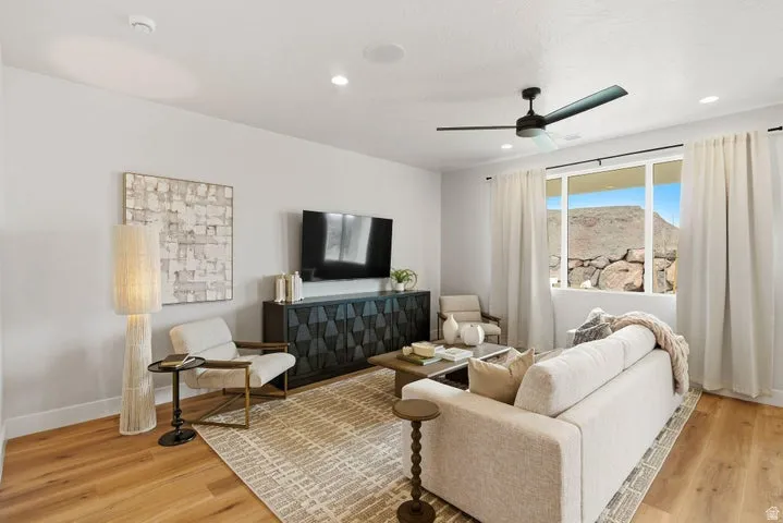Spacious living area featuring wood-finish flooring and recessed lighting