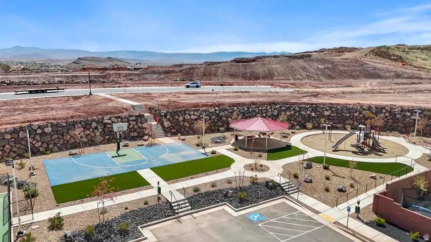 Community recreation area featuring a basketball court, covered gazebo, and playground structure