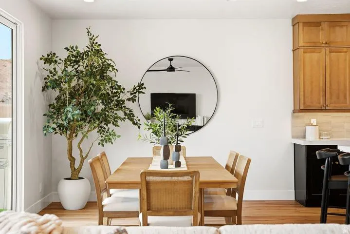 Dining area featuring wood-finish flooring and a large glass slider