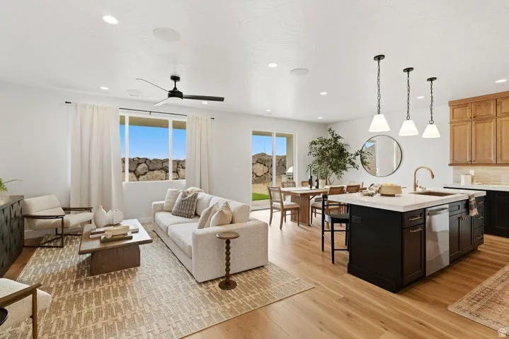 Open-concept living space featuring wood-finish flooring, recessed lighting, and a contemporary ceiling fan