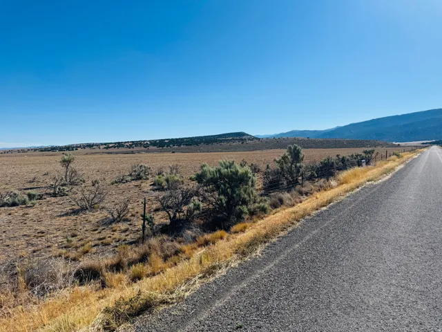 Expansive undeveloped land featuring a clear horizon and distant mountains