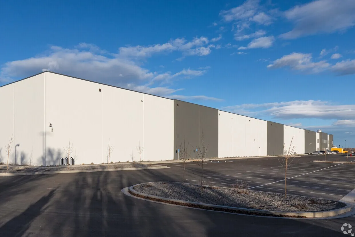 Large-scale commercial building featuring a two-tone exterior with white and gray panels