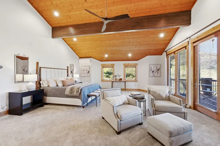 Vaulted wood-paneled ceiling with exposed beam