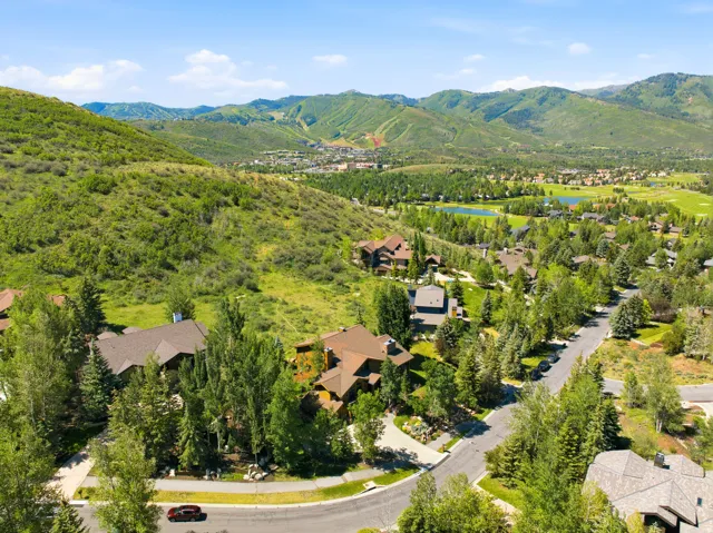 Residential community featuring custom homes, mature trees, and paved roads