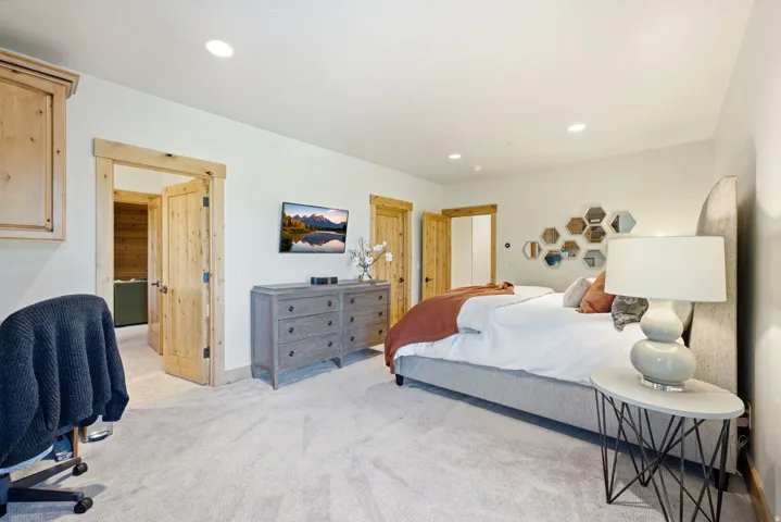 Spacious room featuring light-toned walls and plush carpeting