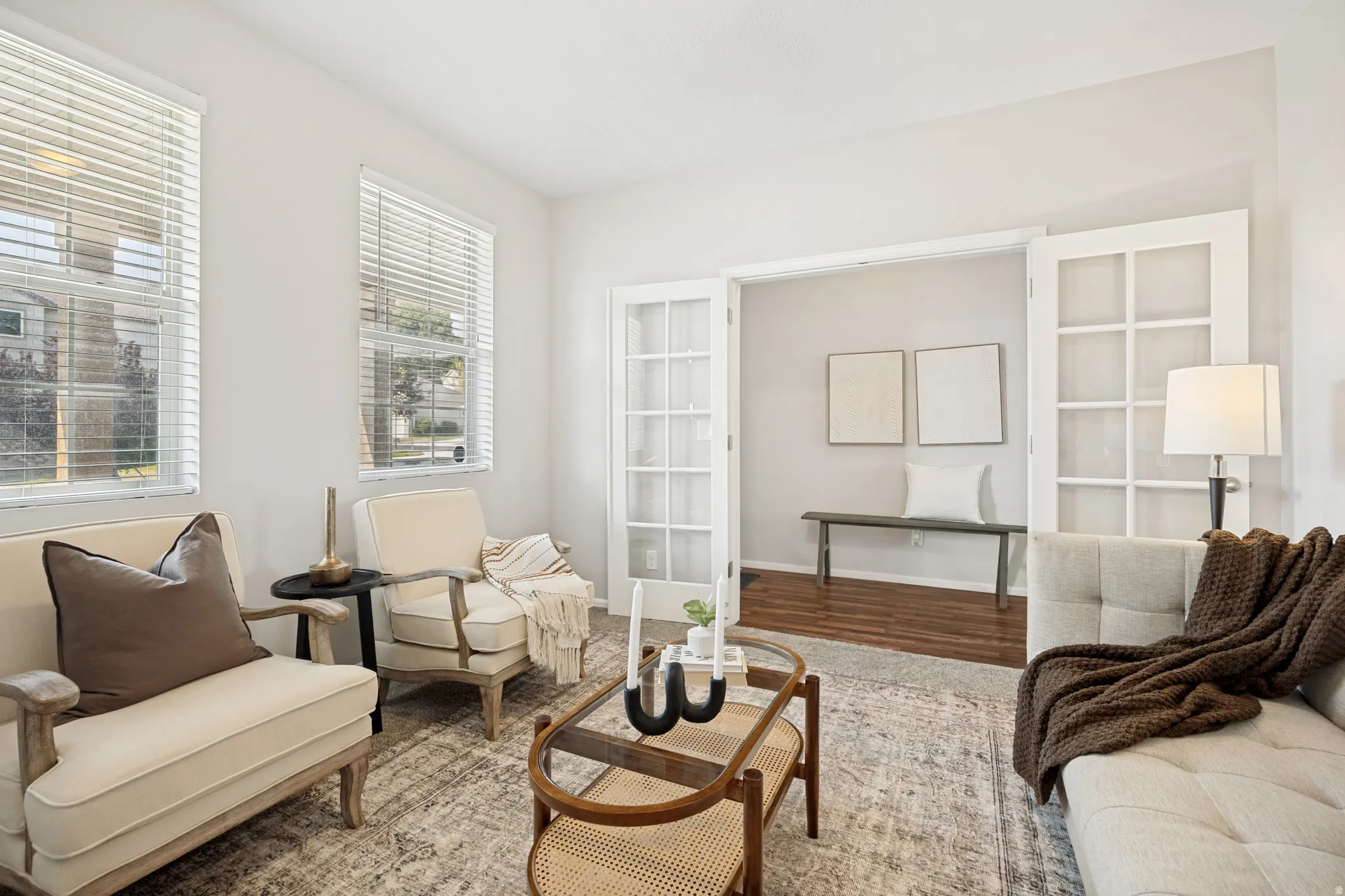 Living area featuring two large windows with horizontal blinds, providing ample natural illumination
