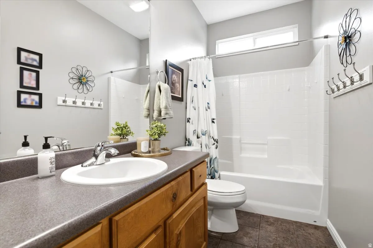 Bathroom vanity with an integrated sink and chrome faucet, set against a full-width mirror