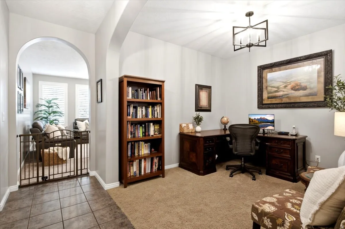 Dedicated workspace featuring neutral-toned walls and carpet flooring