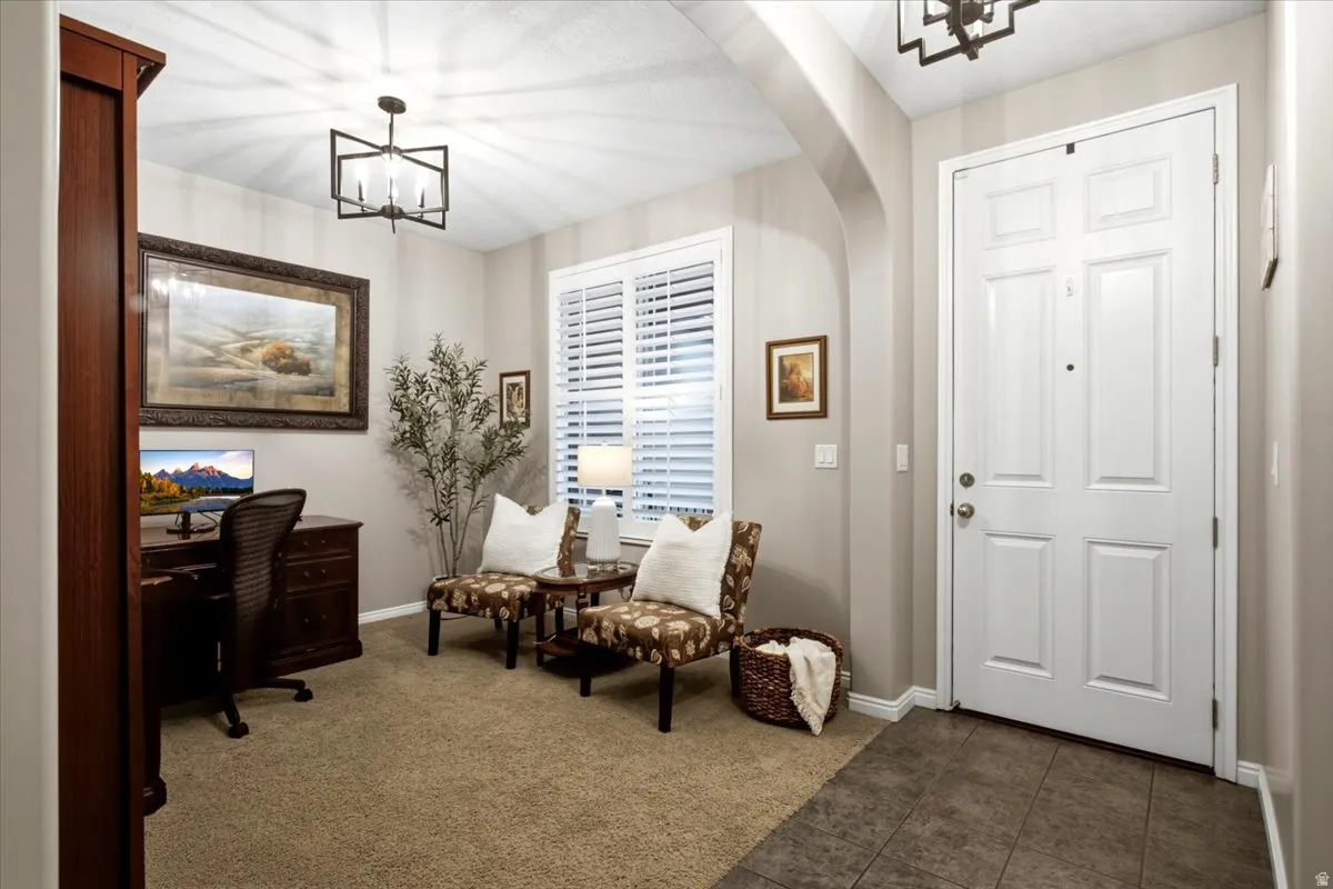 Entryway featuring a paneled door, archway, and tile flooring